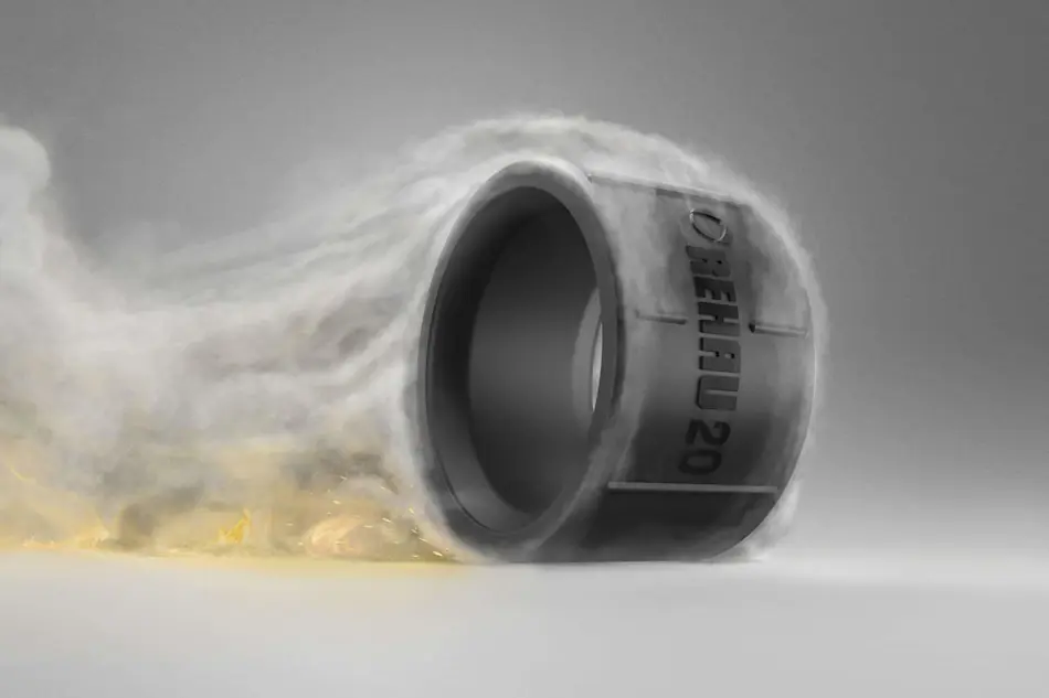 A black pipe connector surrounded by smoke or vapor with hints of yellow flame at the base.