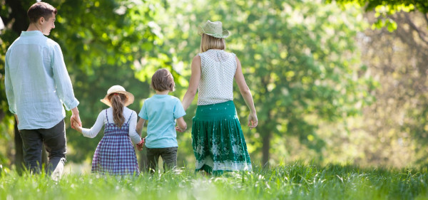 A family walking outside in a field.