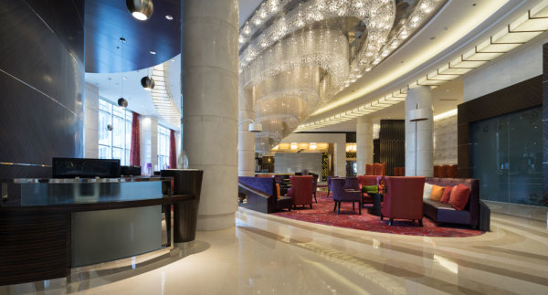 The lobby of a nice hotel with a large crystal chandelier