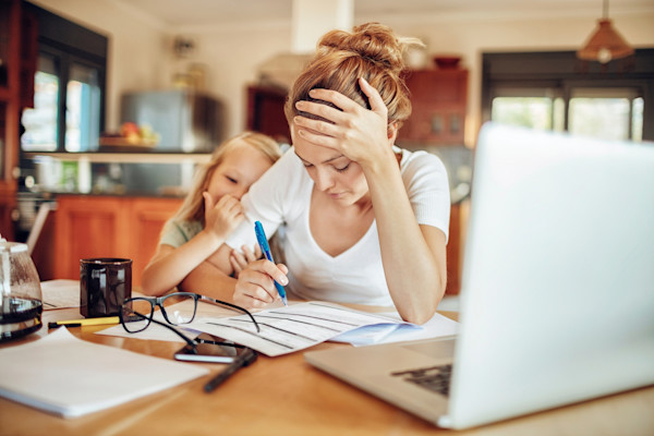 Mom looking through documents with her daughter next to her