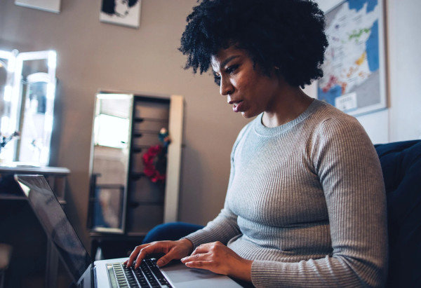 Woman in grey at home on laptop. JPG