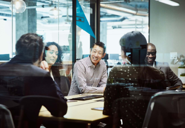 Co-workers laughing in a meeting