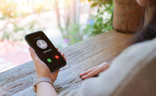 Close up of someone holding a smartphone and getting an unknown call