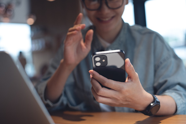 A female office worker looks at her phone