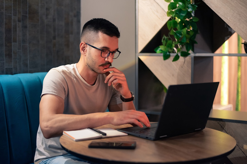 Man sits at a laptop