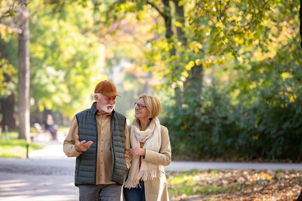 Older couple walking through the park