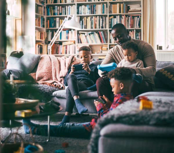 father with children on devices