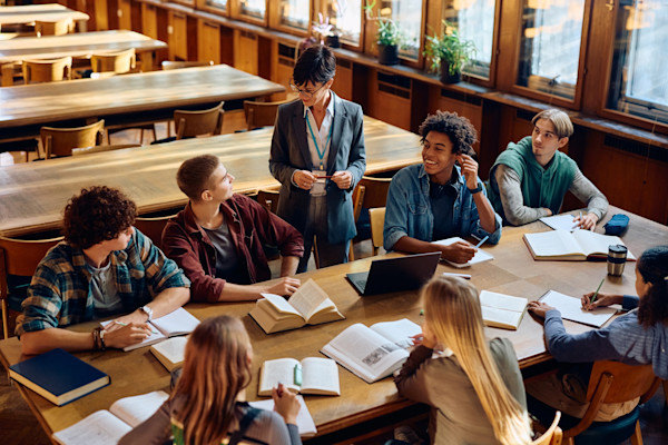 Teacher talking to several students