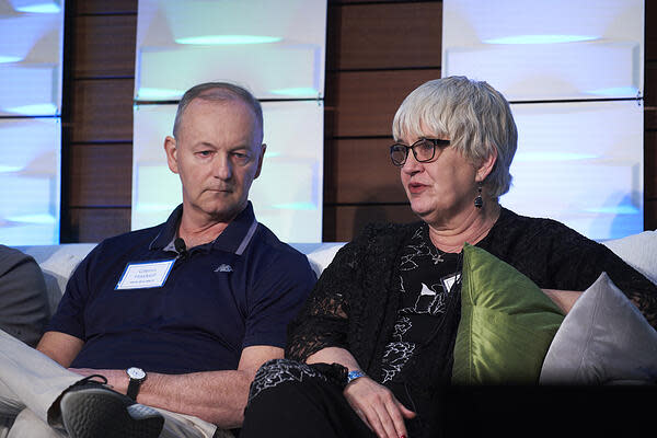 Two panelists sit on the couch at partner summit