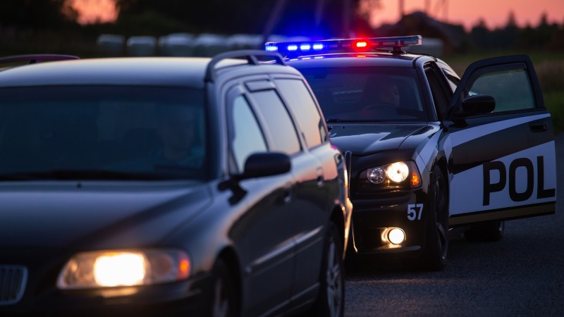 Police car pulling over another car