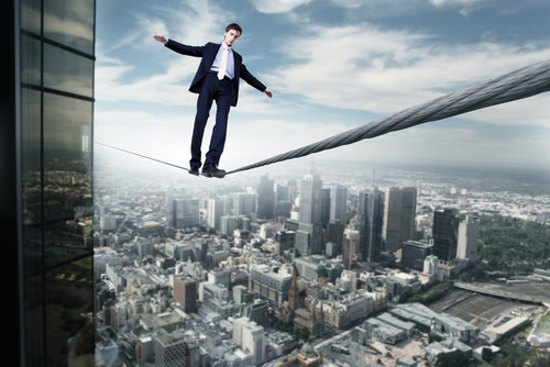 Business man balancing on a rope