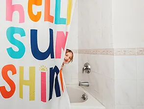 Kid peaking behind shower curtain
