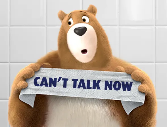 Leanoard Bear holding up Can't Talk Right Now on toilet paper