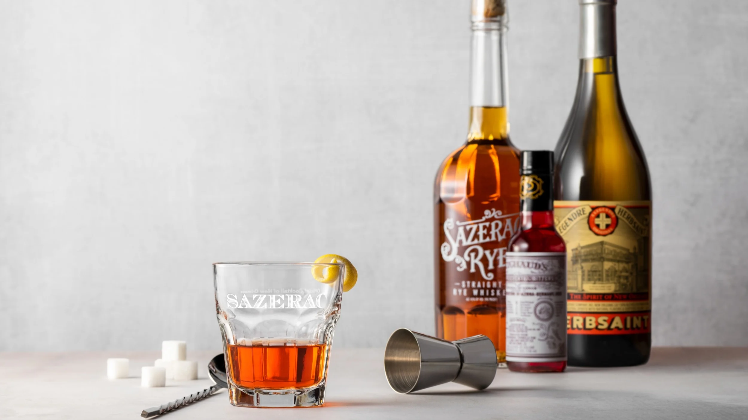 Sazerac cocktail served beside Sazerac Rye whiskey and cocktail ingredient