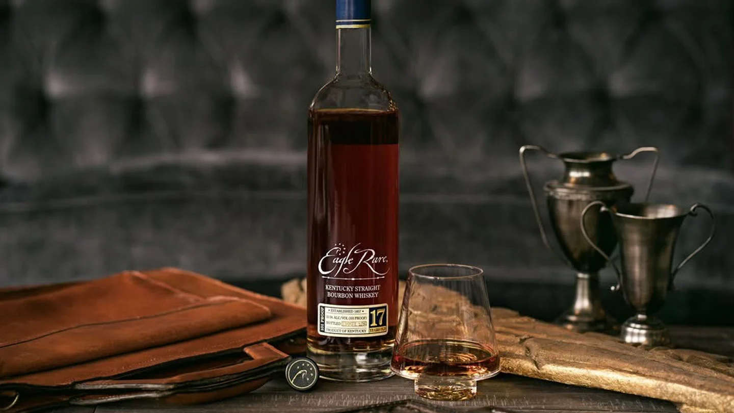 Eagle Rare 17 bourbon whiskey displayed beside a tasting glass.