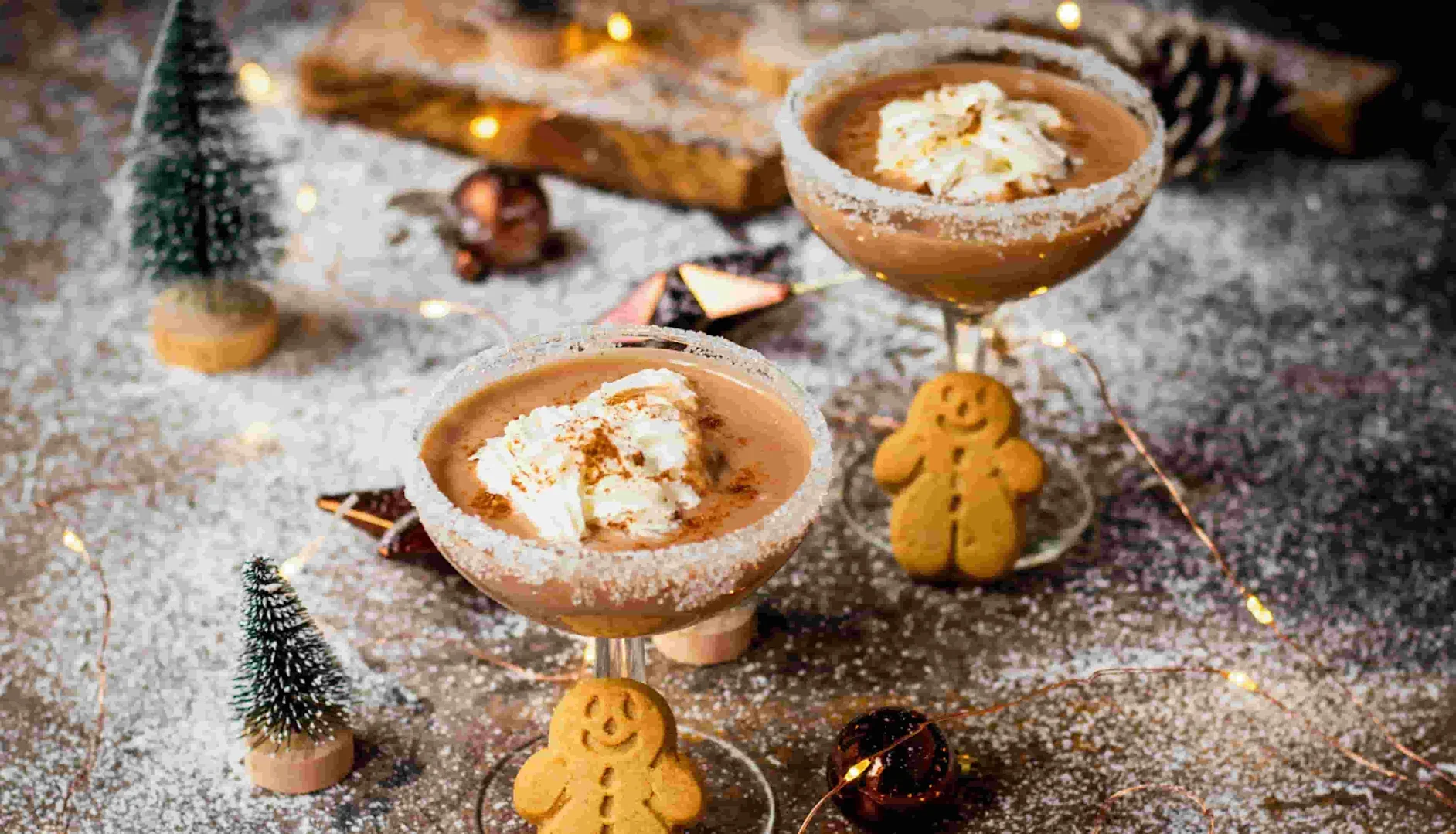 Peppermint Espresso Martini Christmas cocktails complete with mini gingerbread people biscuits and cream as garnish.