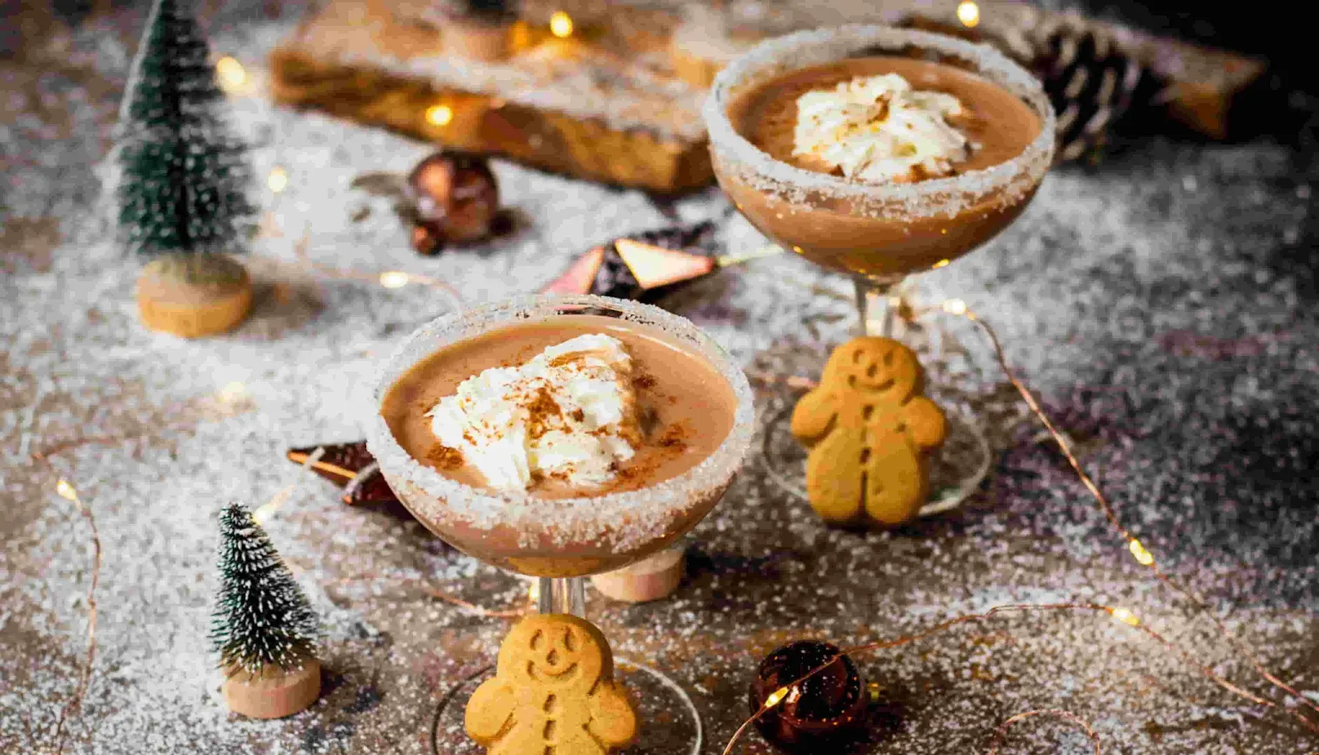 Peppermint Espresso Martini Christmas cocktails complete with mini gingerbread people biscuits and cream as garnish.