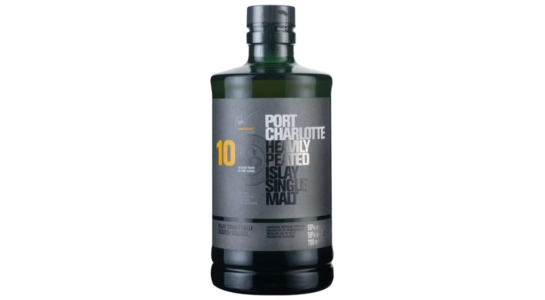 A dark green bottle of Port Charlotte 10-year-old heavily peated Islay single malt Scotch whisky with a gray label featuring bold white and yellow text, on a plain white background.