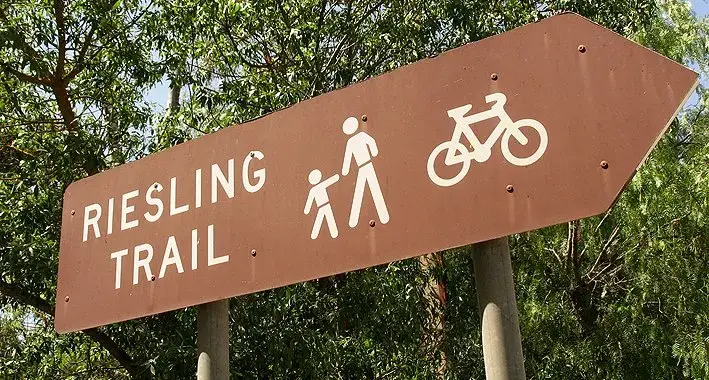 A tourist signpost pointing to the Riesling Trail.