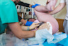 This supportive midwife is supporting the birthing person's perineum as their baby crowns.