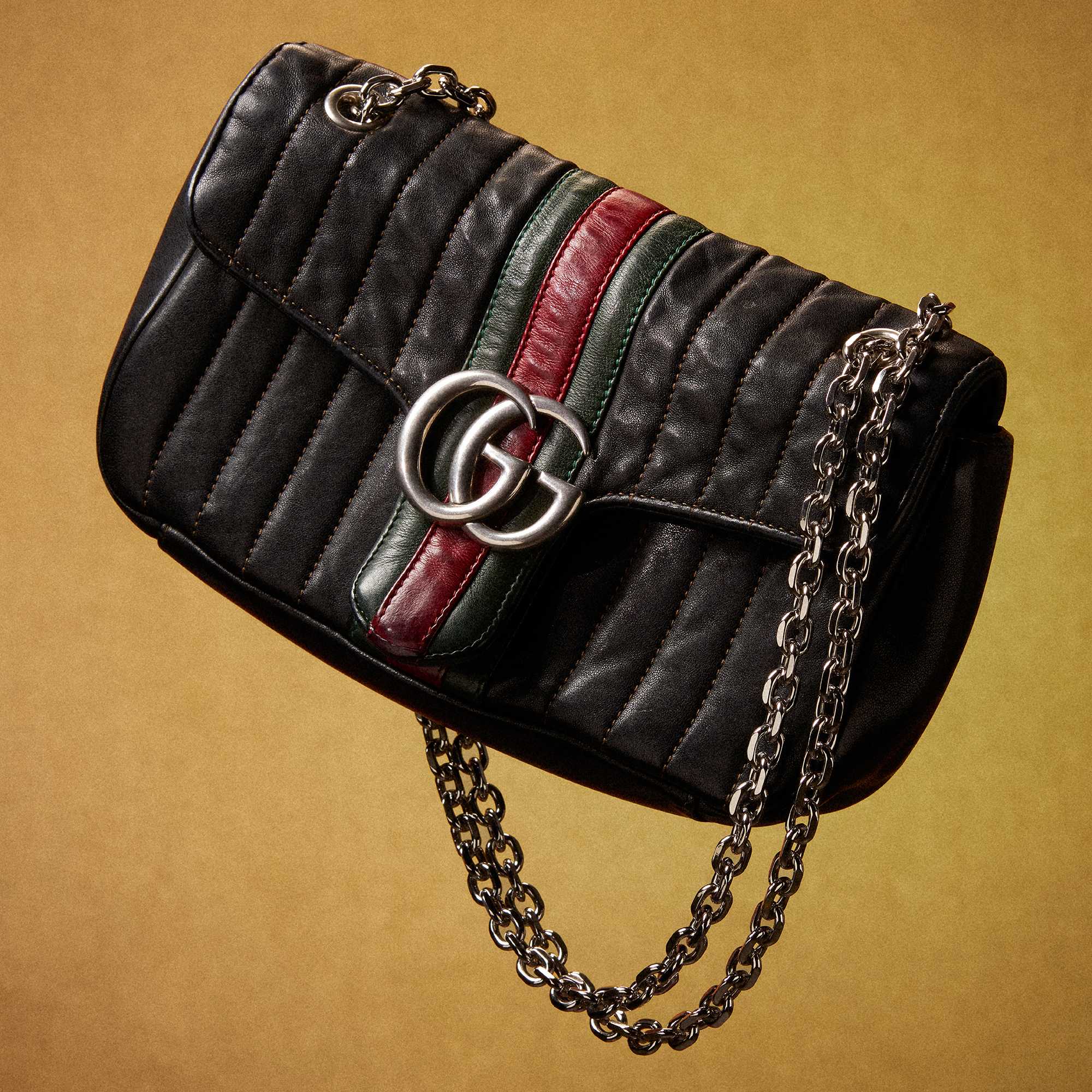 Black Gucci suit and handbag