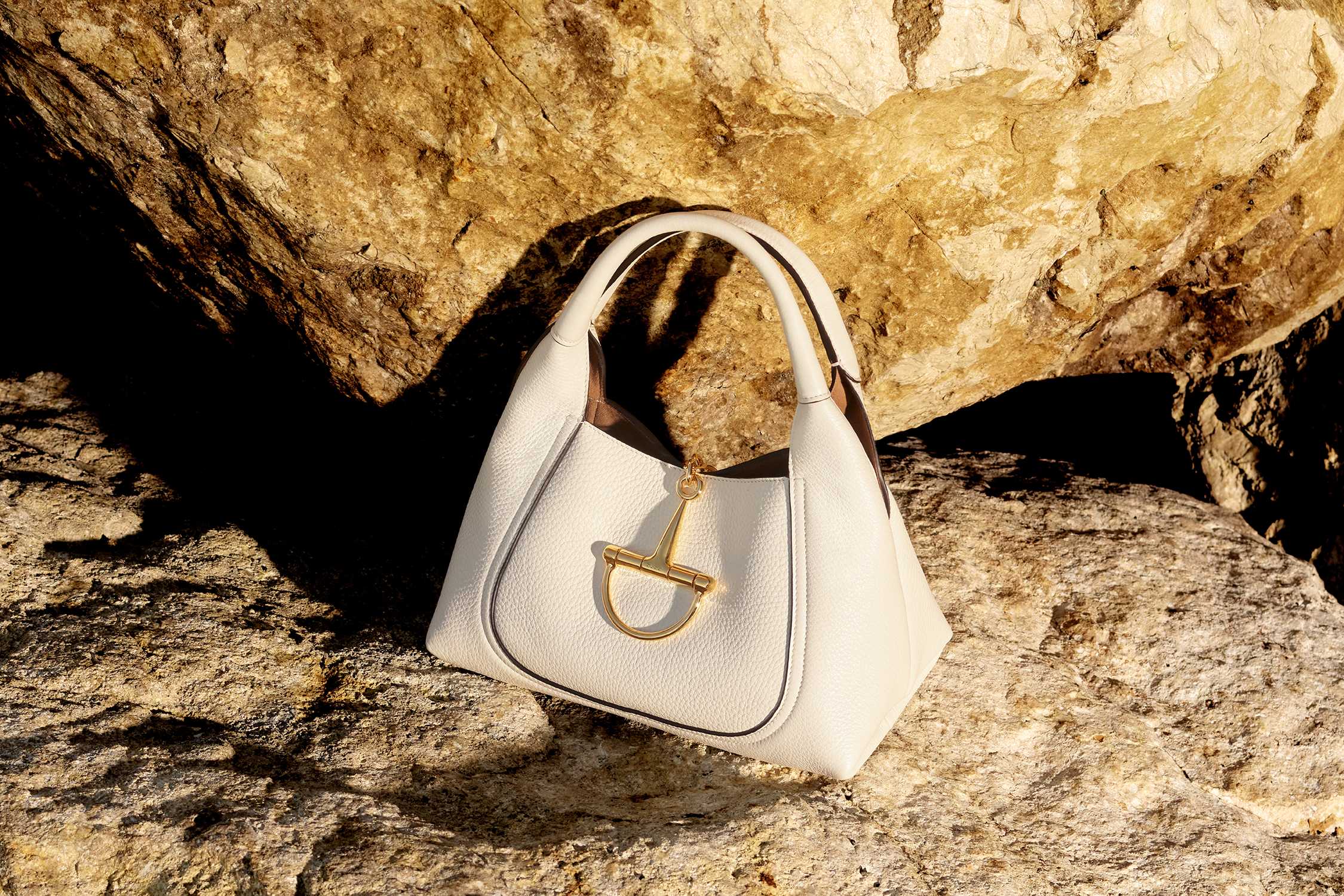 White handbag with gold hardware