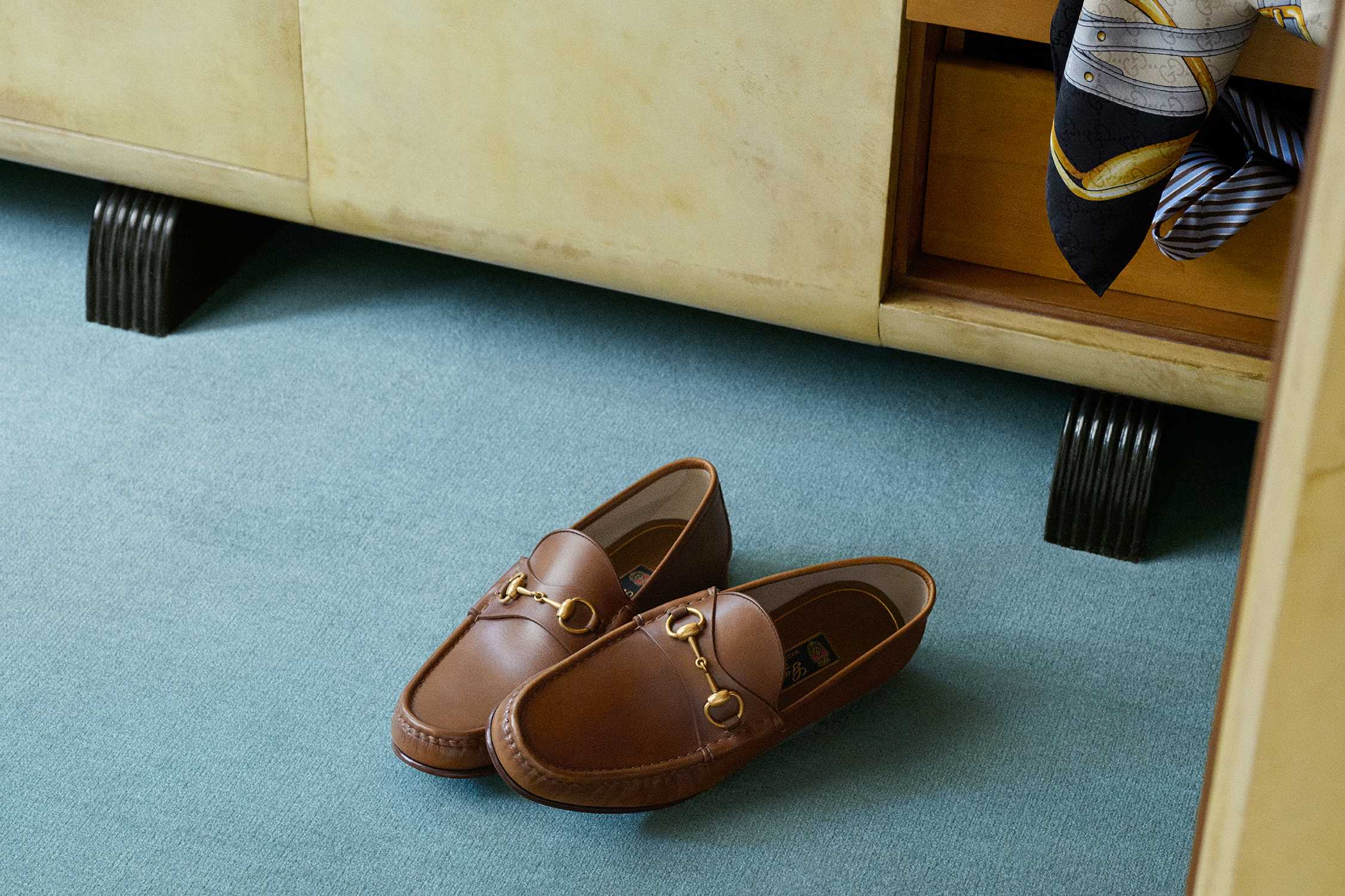 Brown Gucci loafers on carpet