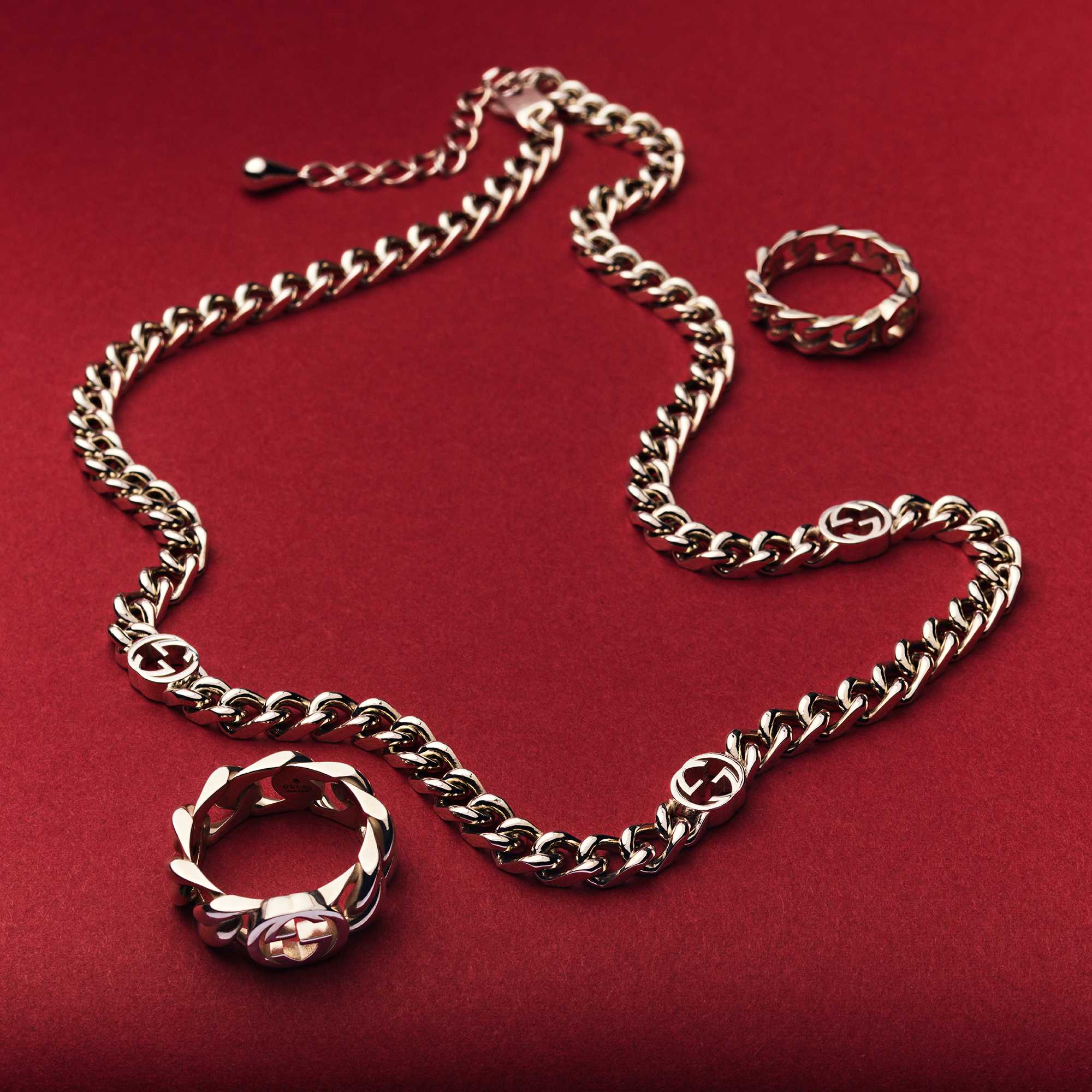 Gold Gucci jewelry on red