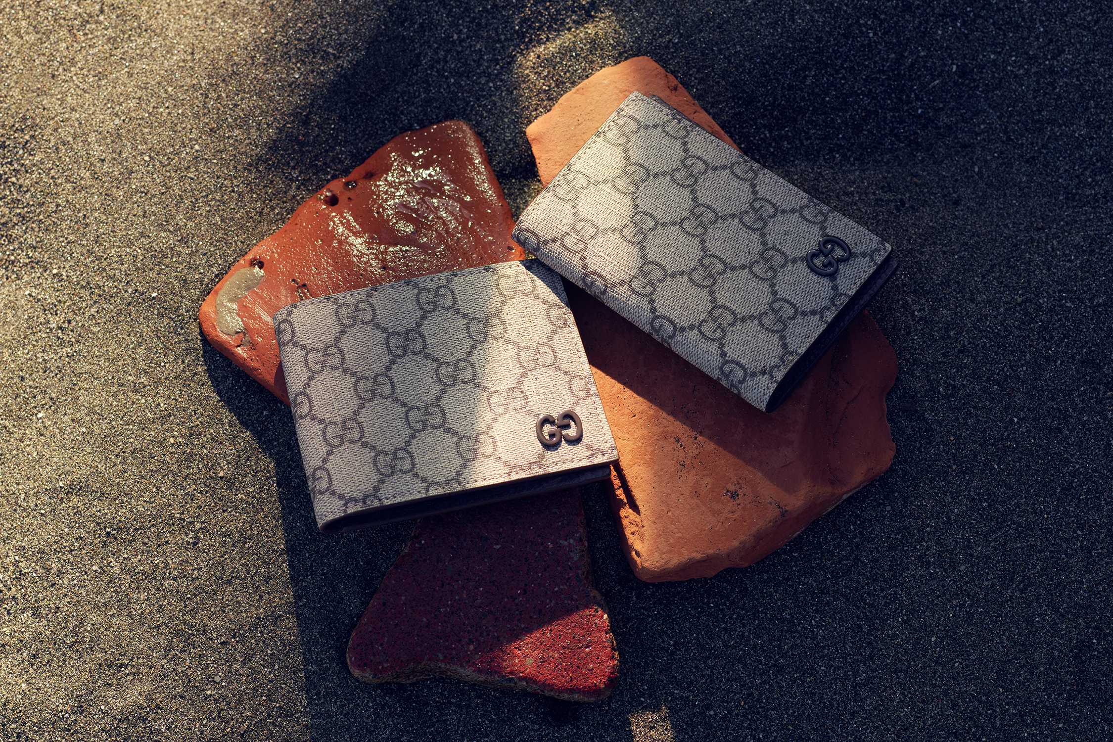 Grey Gucci wallets on beach