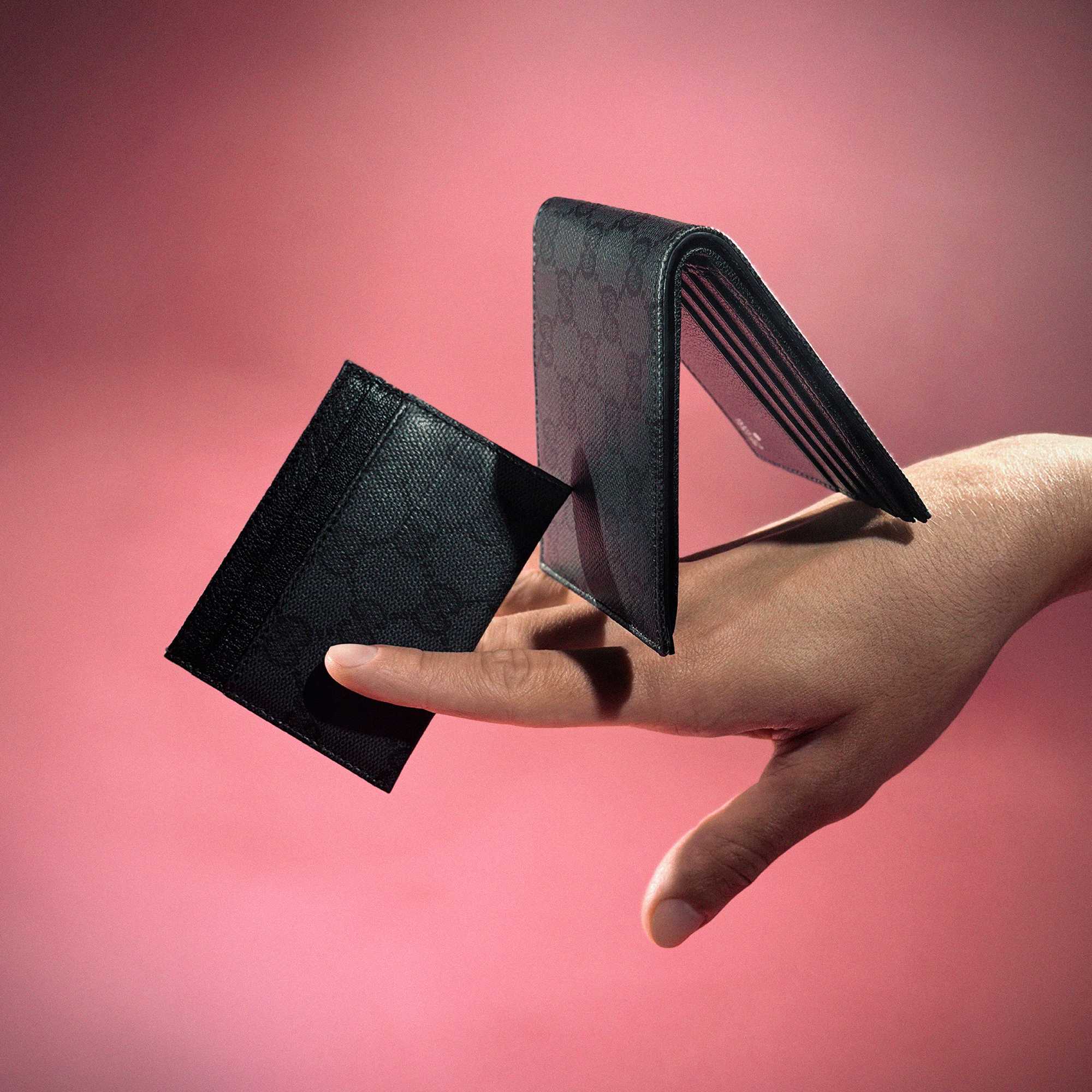 Black Gucci wallets on pink
