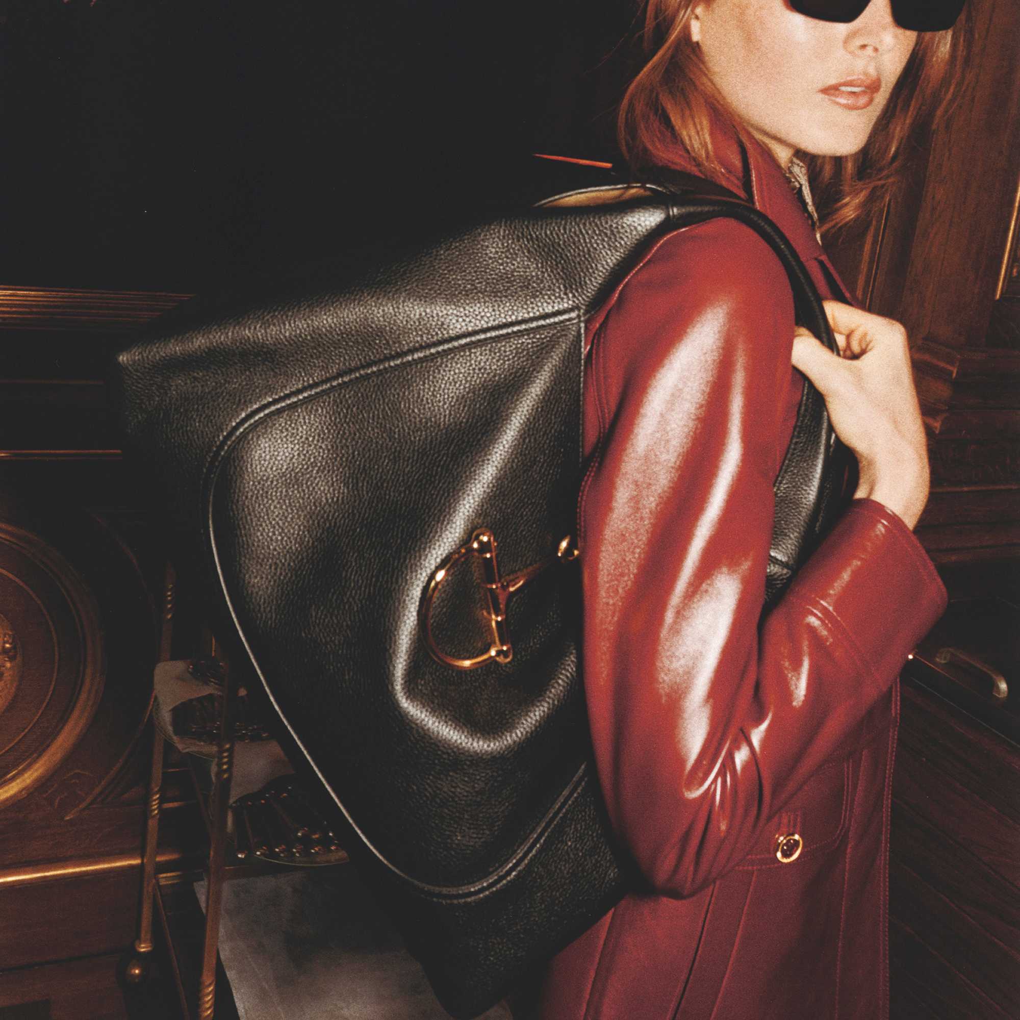 Black Gucci bag, red coat.