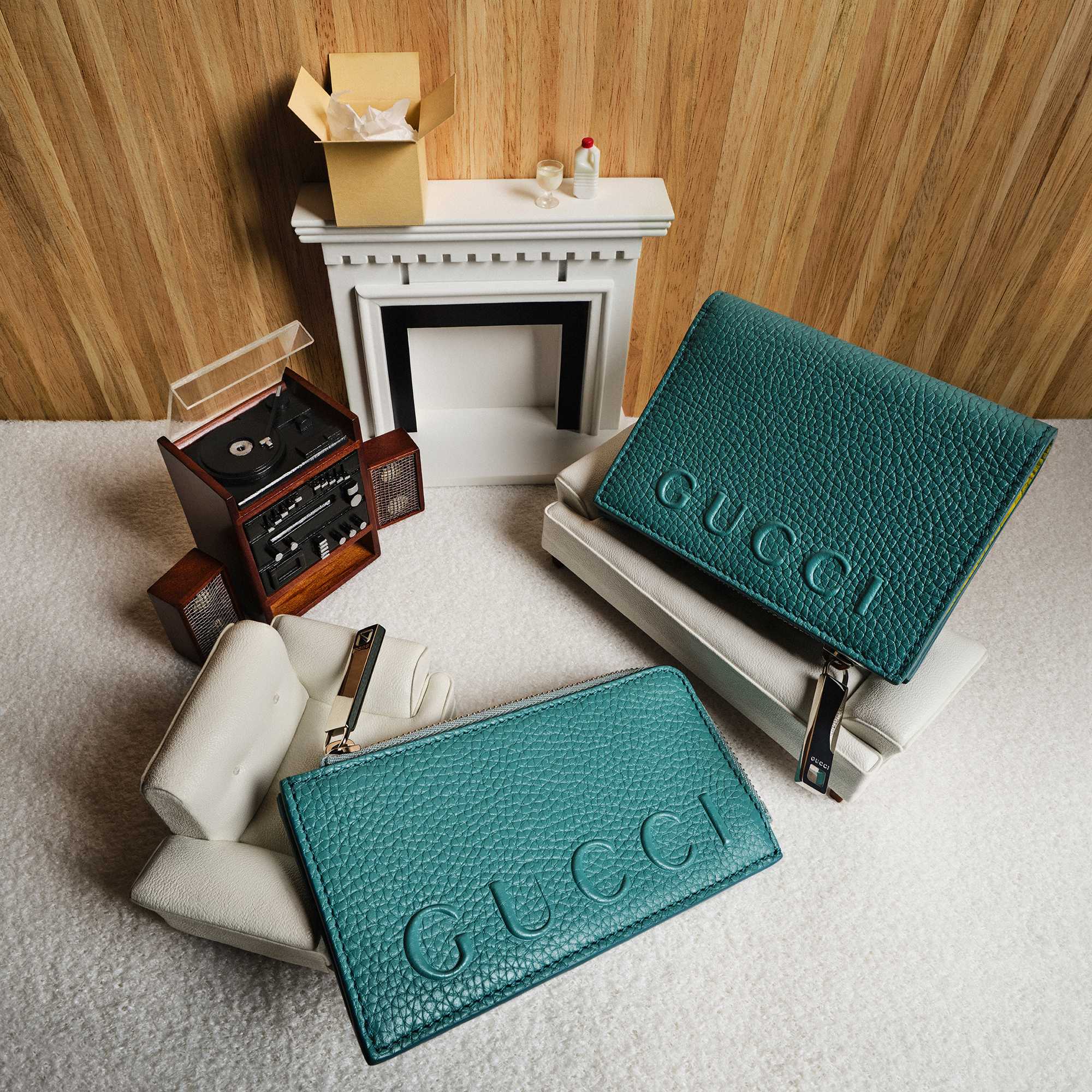 Teal Gucci leather accessories displayed.