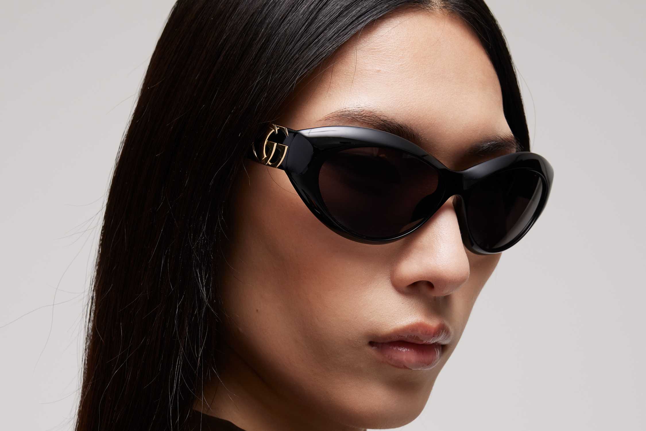 Black Gucci cat-eye sunglasses worn.