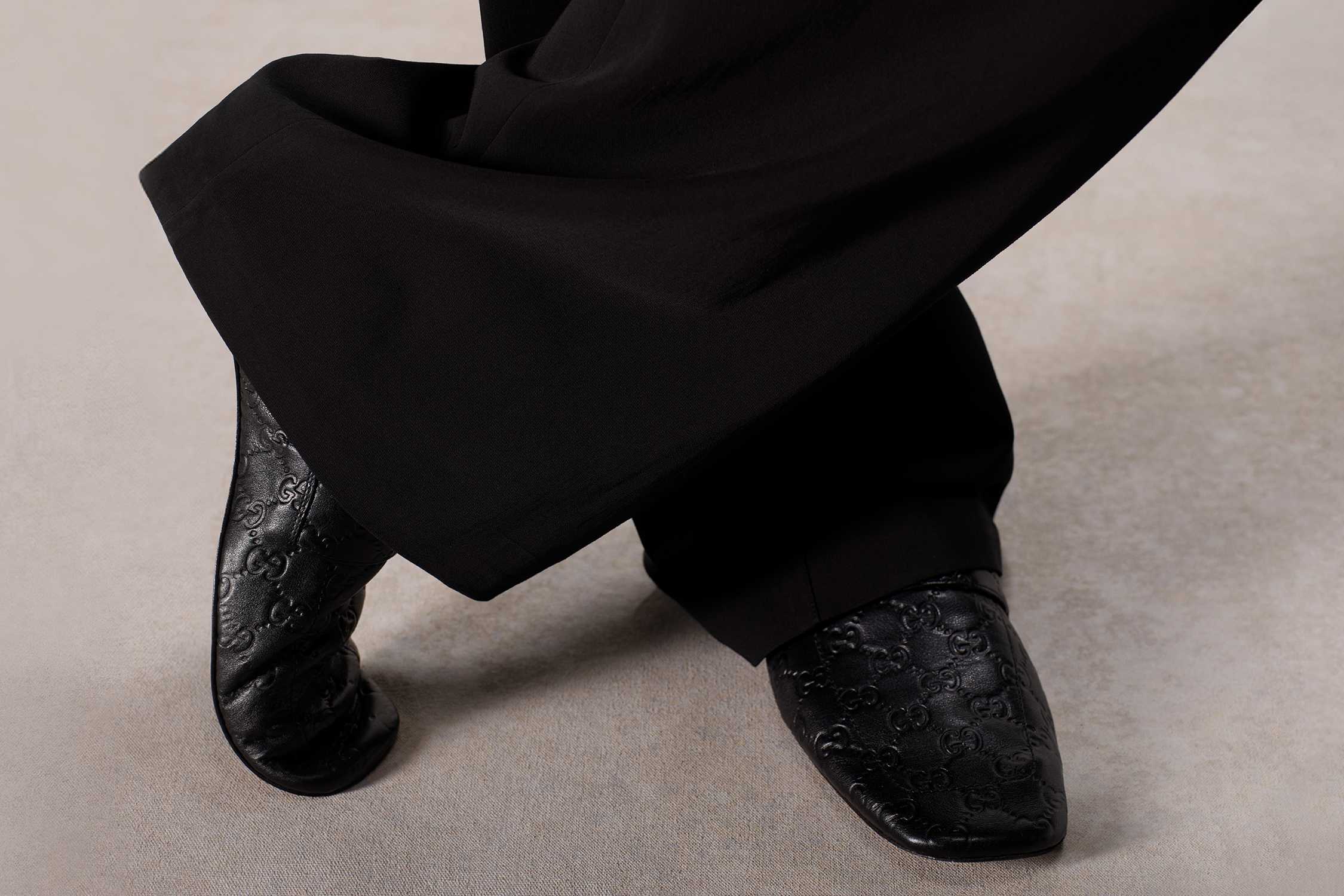 Black Gucci embossed leather shoes