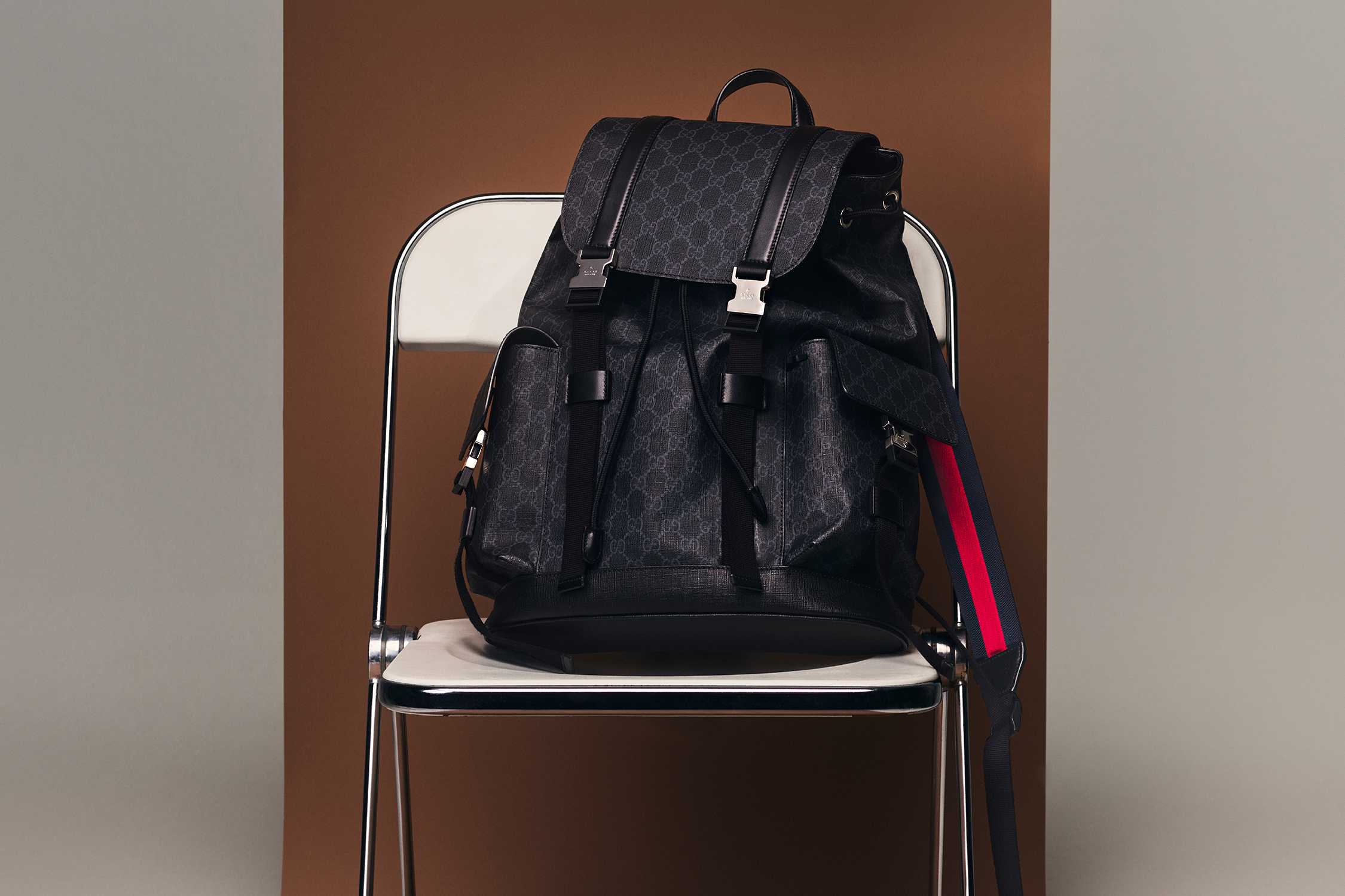 Black Gucci backpack with red-stripe.