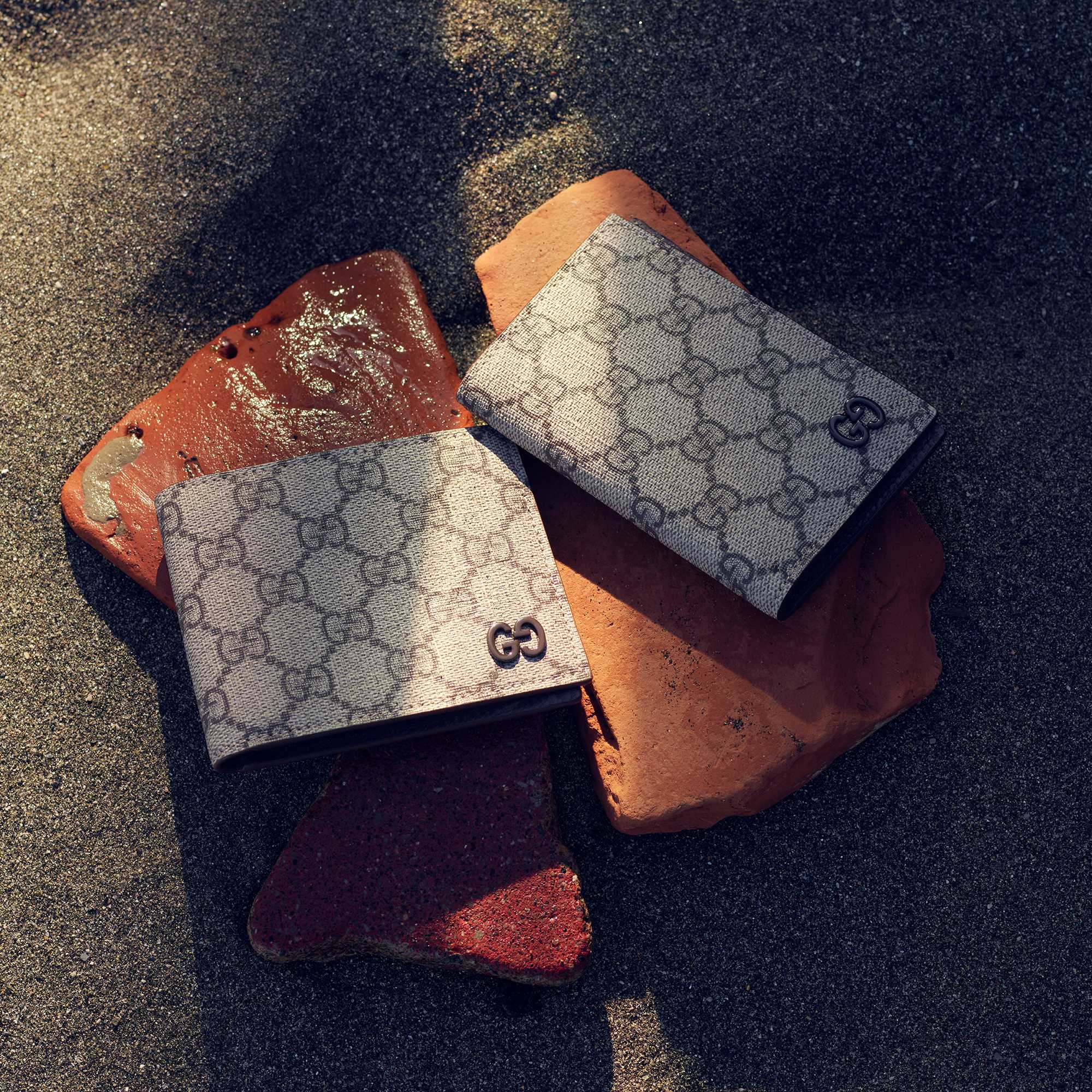Gucci wallets on sand