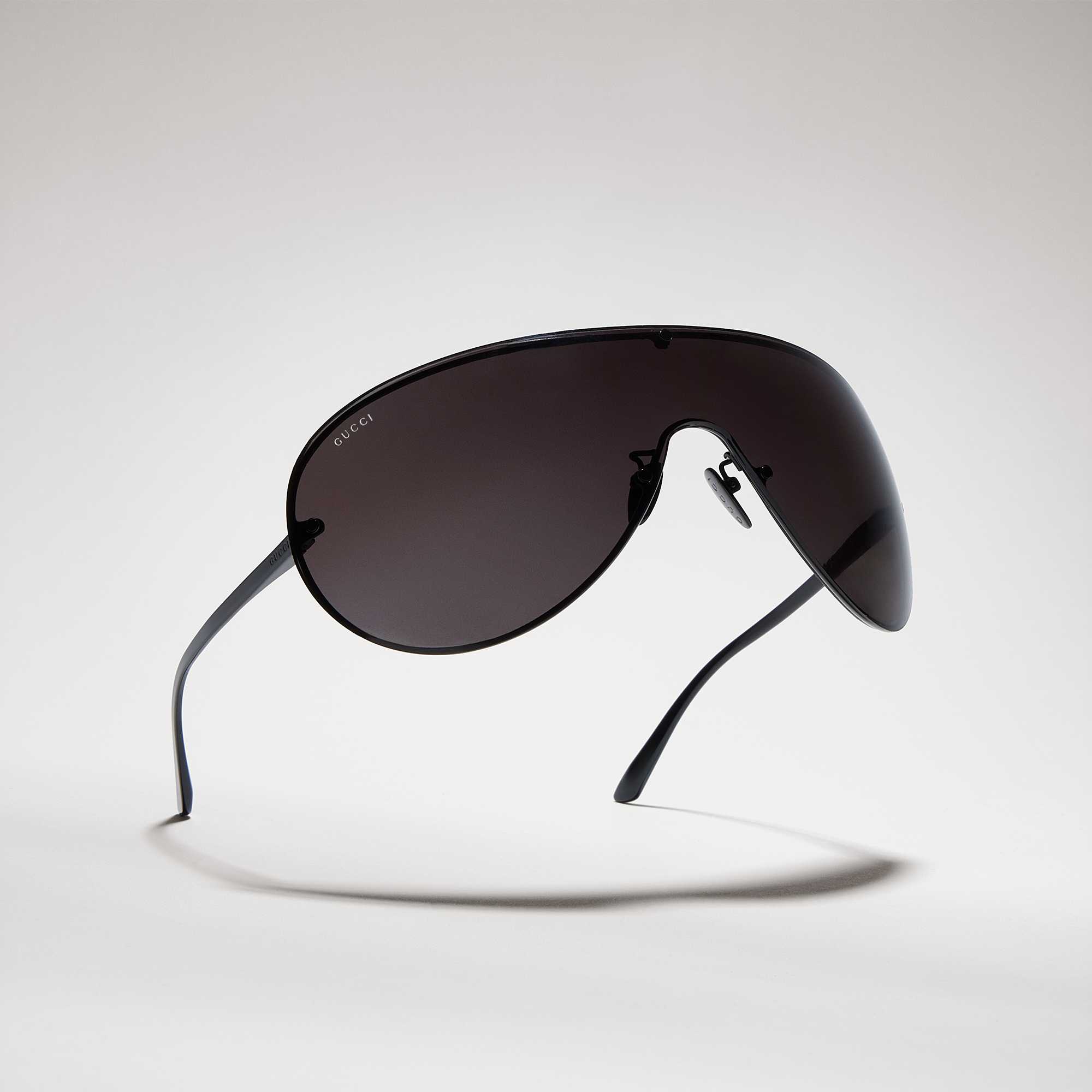 Black Gucci shield sunglasses displayed