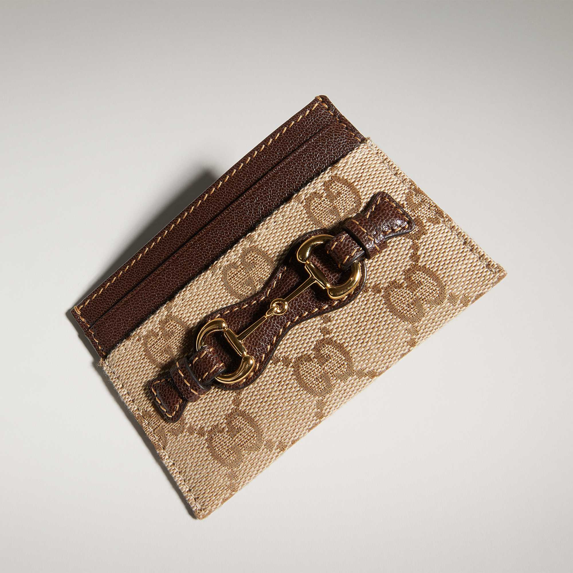 Beige Gucci wallets with red-green stripes.