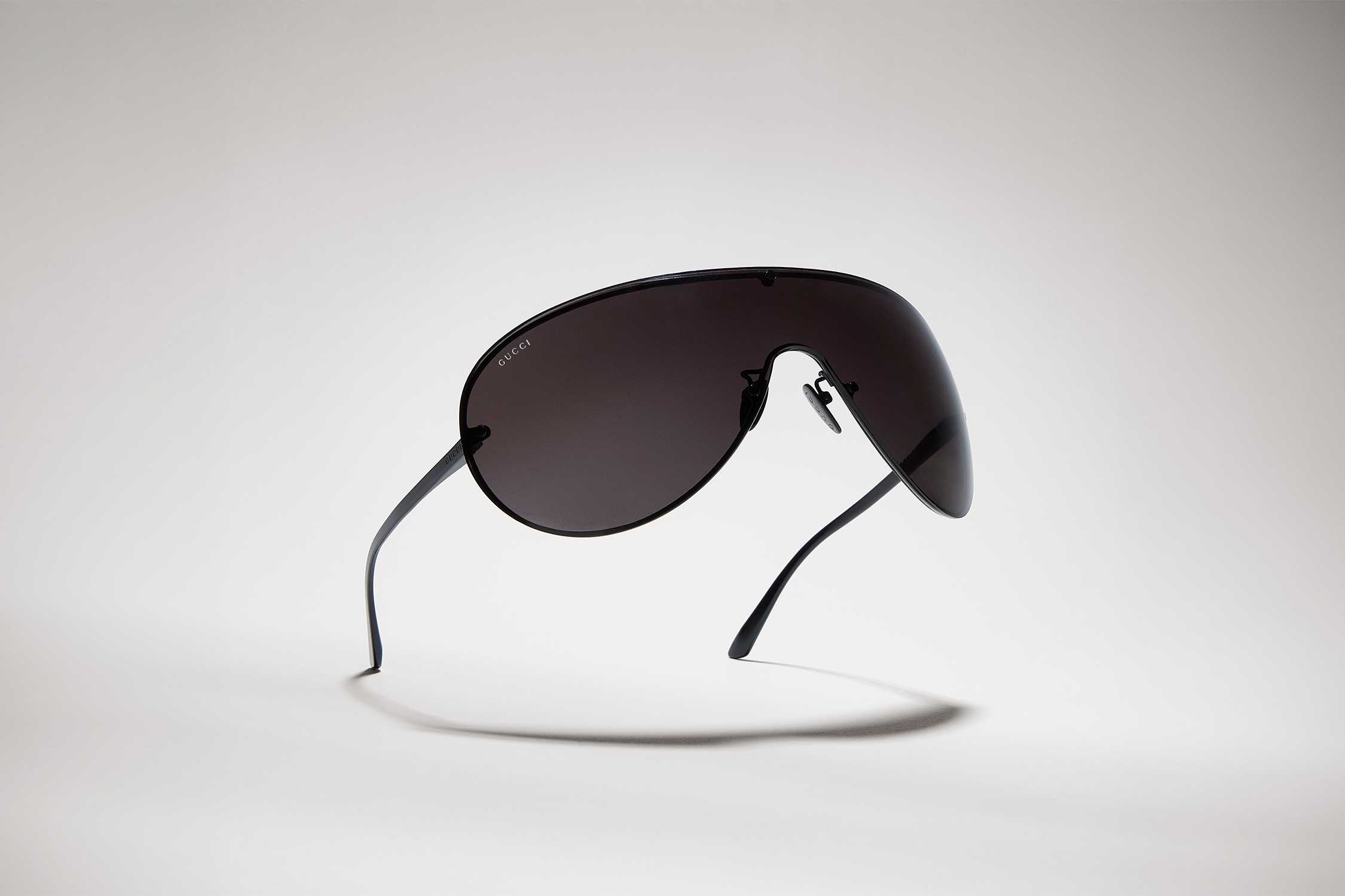 Black Gucci shield sunglasses floating
