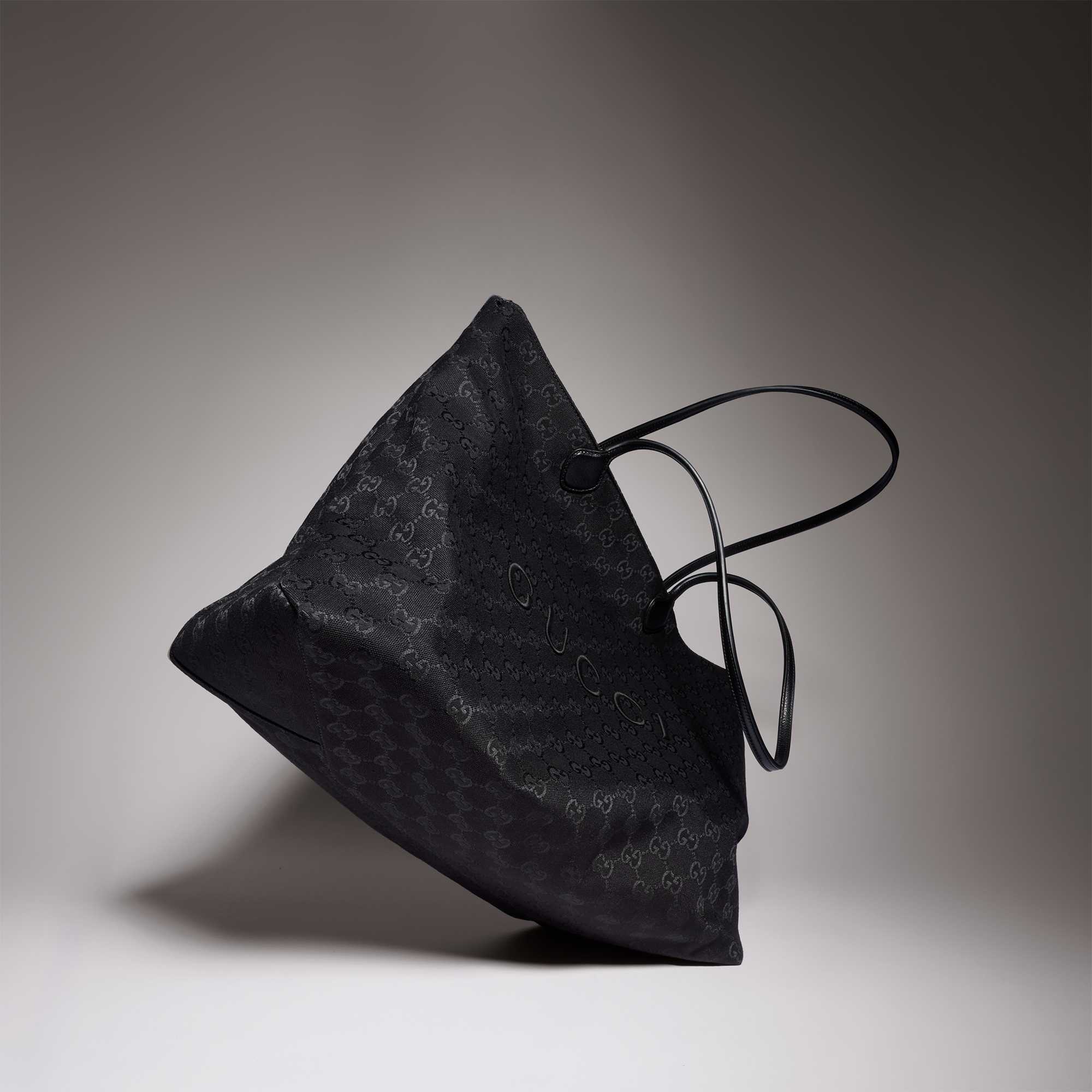 Black Gucci quilted handbag featured.