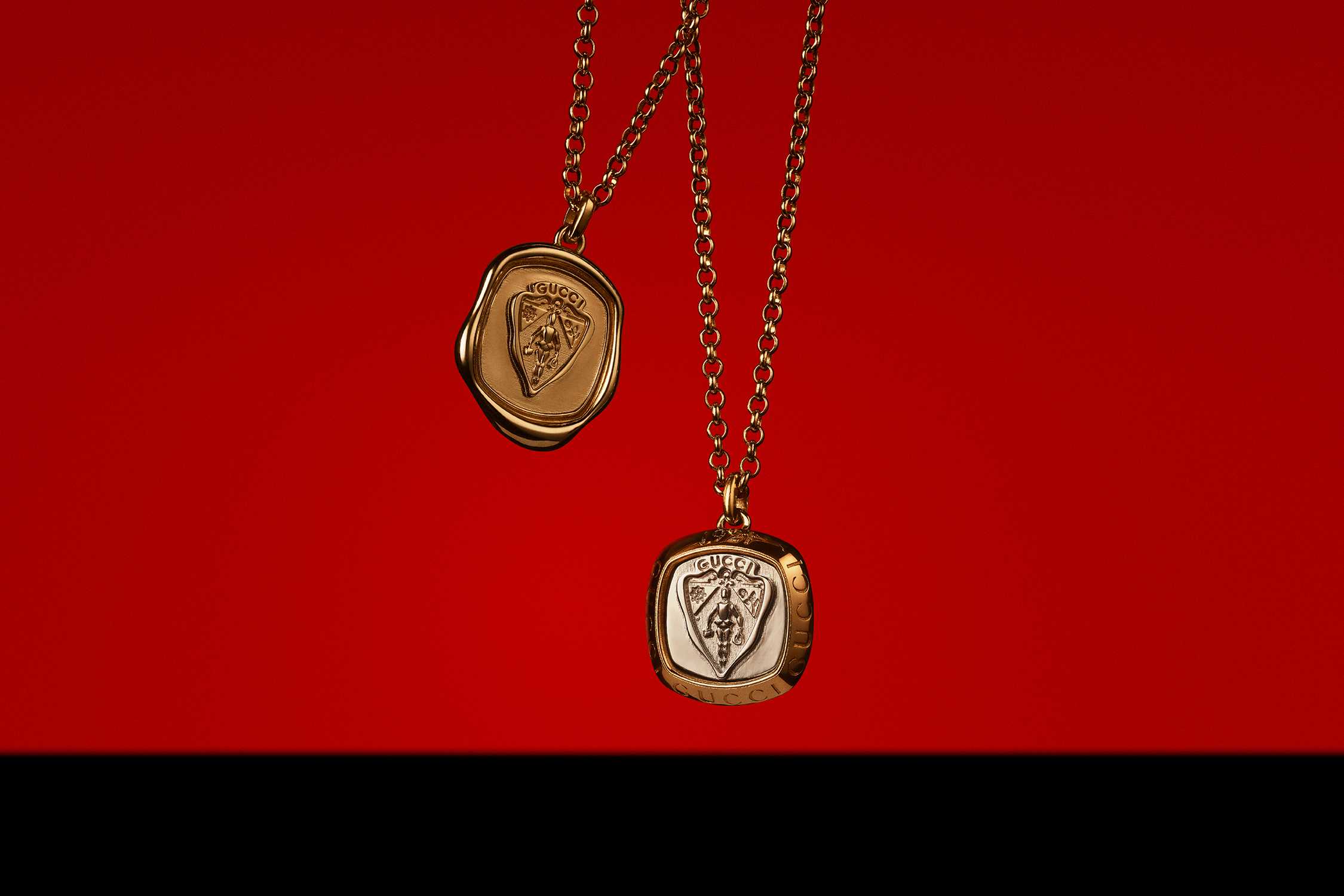 Gold Gucci pendants on red