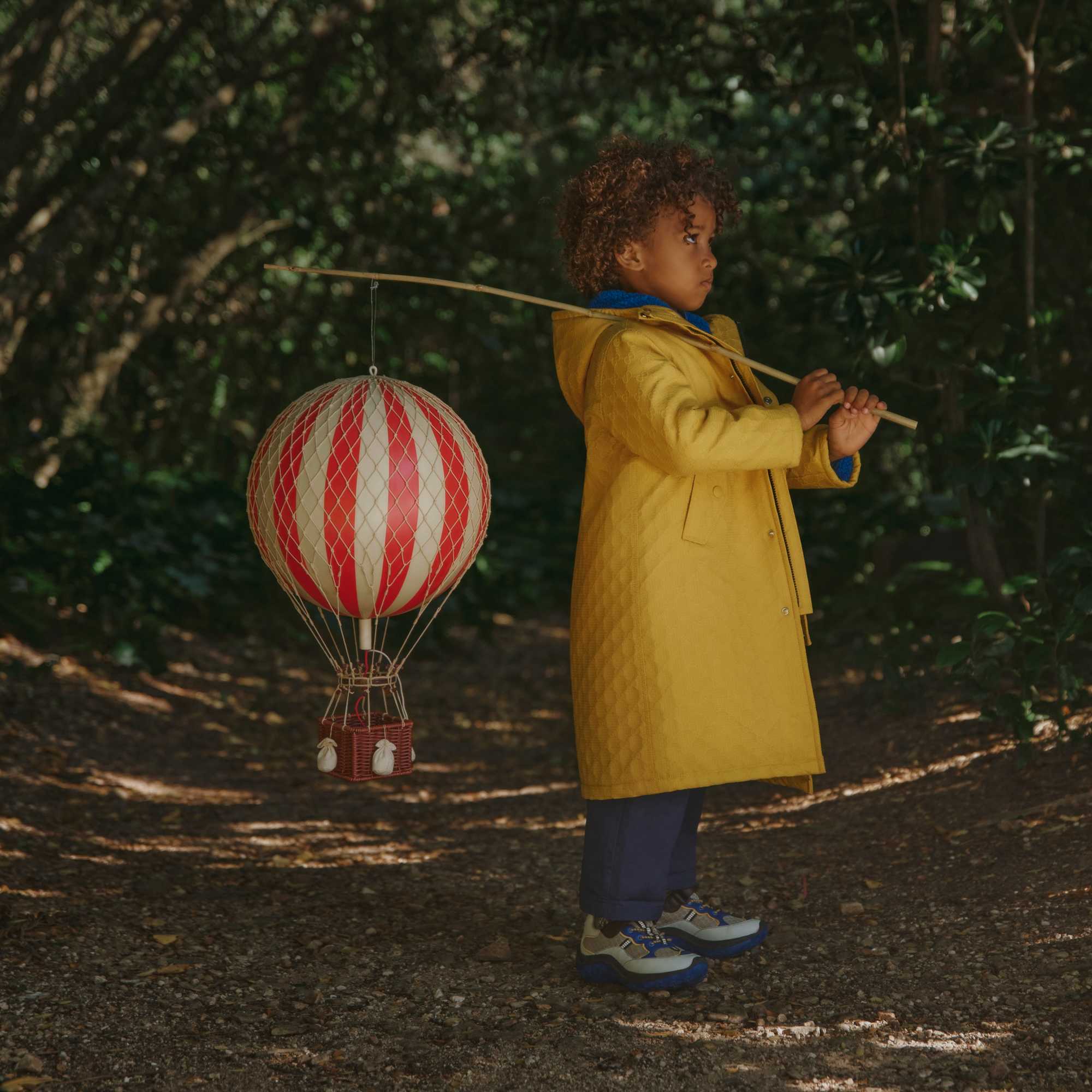 Boy outdoors in green Gucci children's outfit