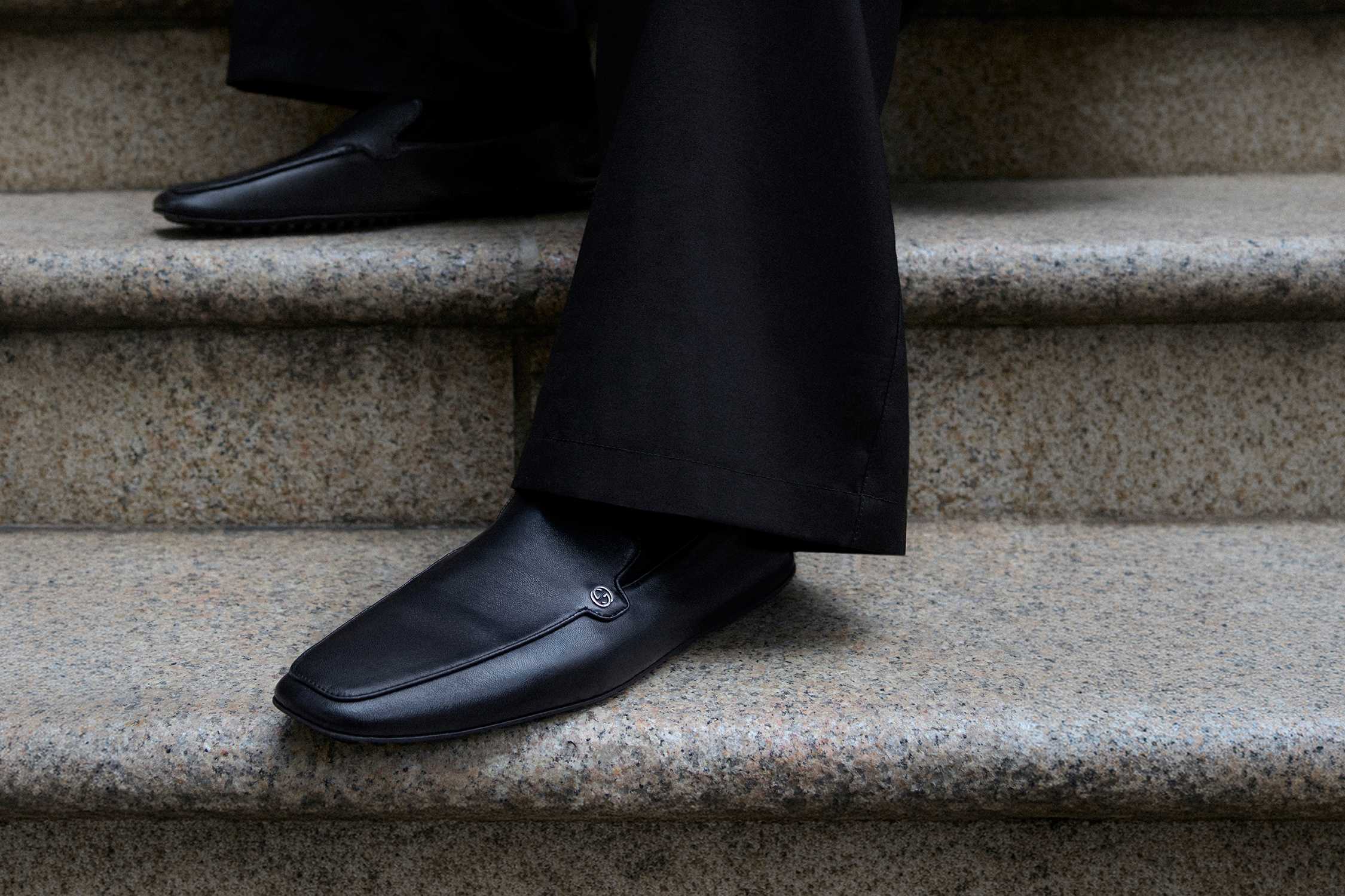 Black Gucci leather loafers steps