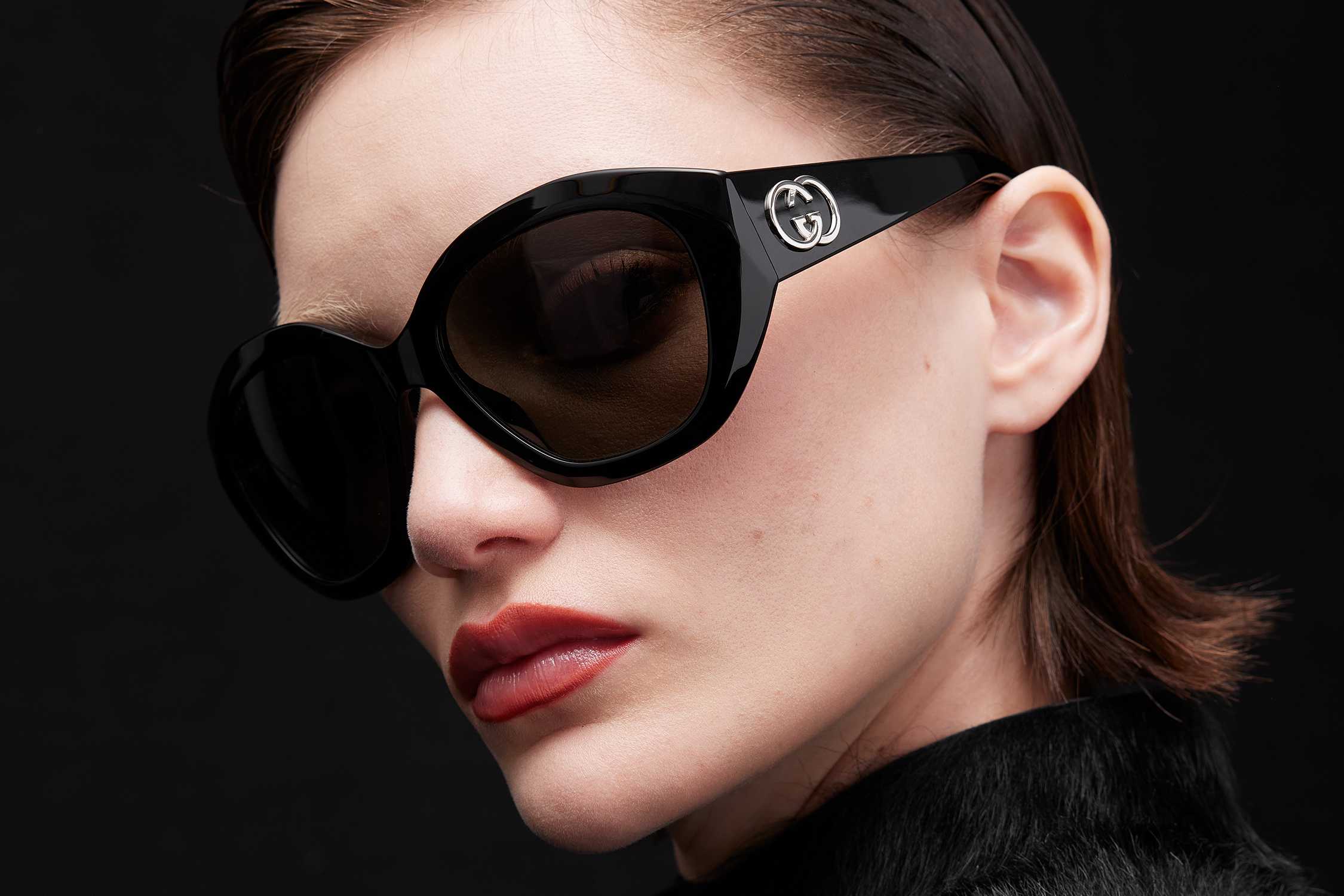 Black oversized Gucci sunglasses worn.