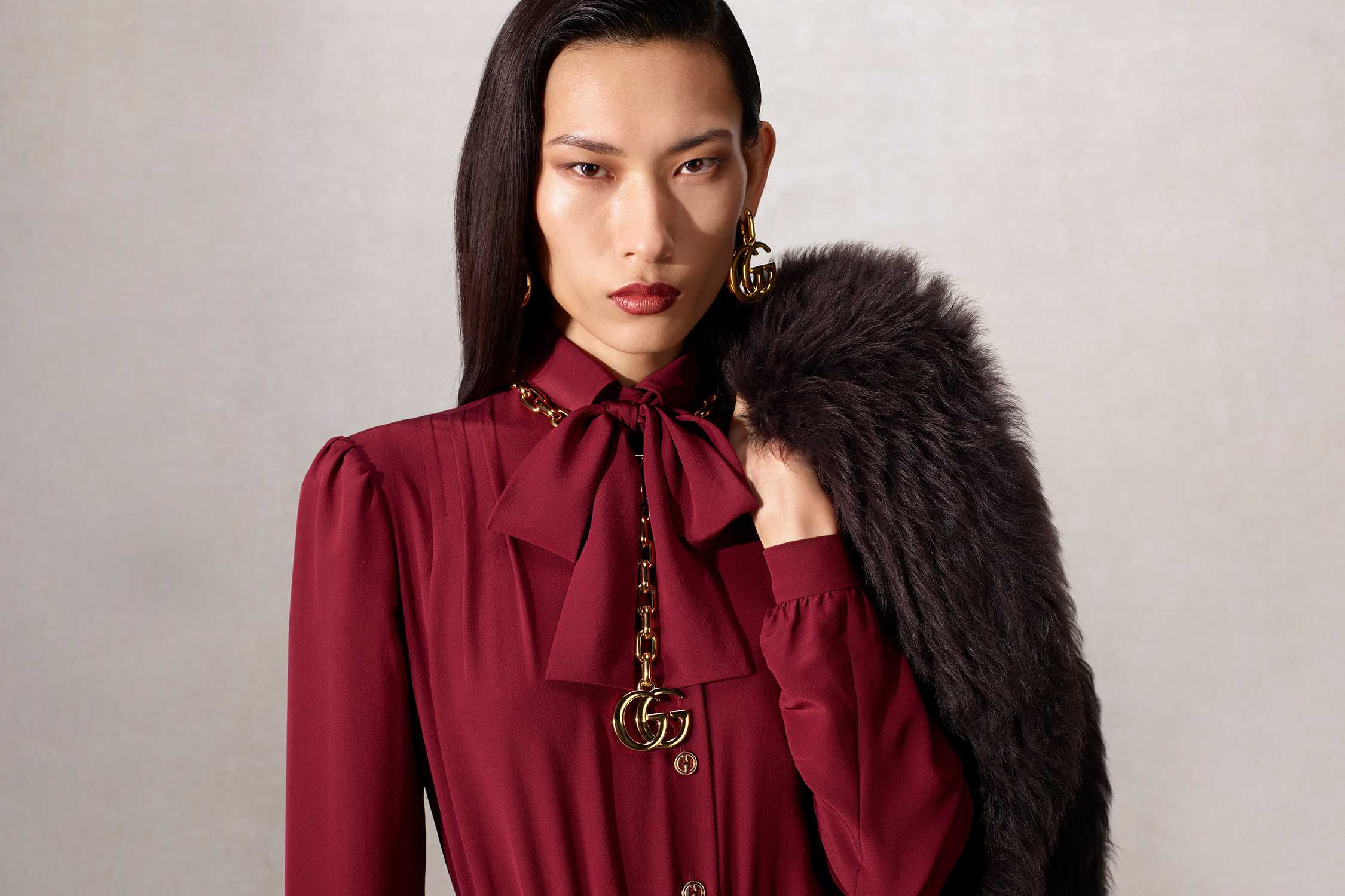 Burgundy Gucci blouse with accessories