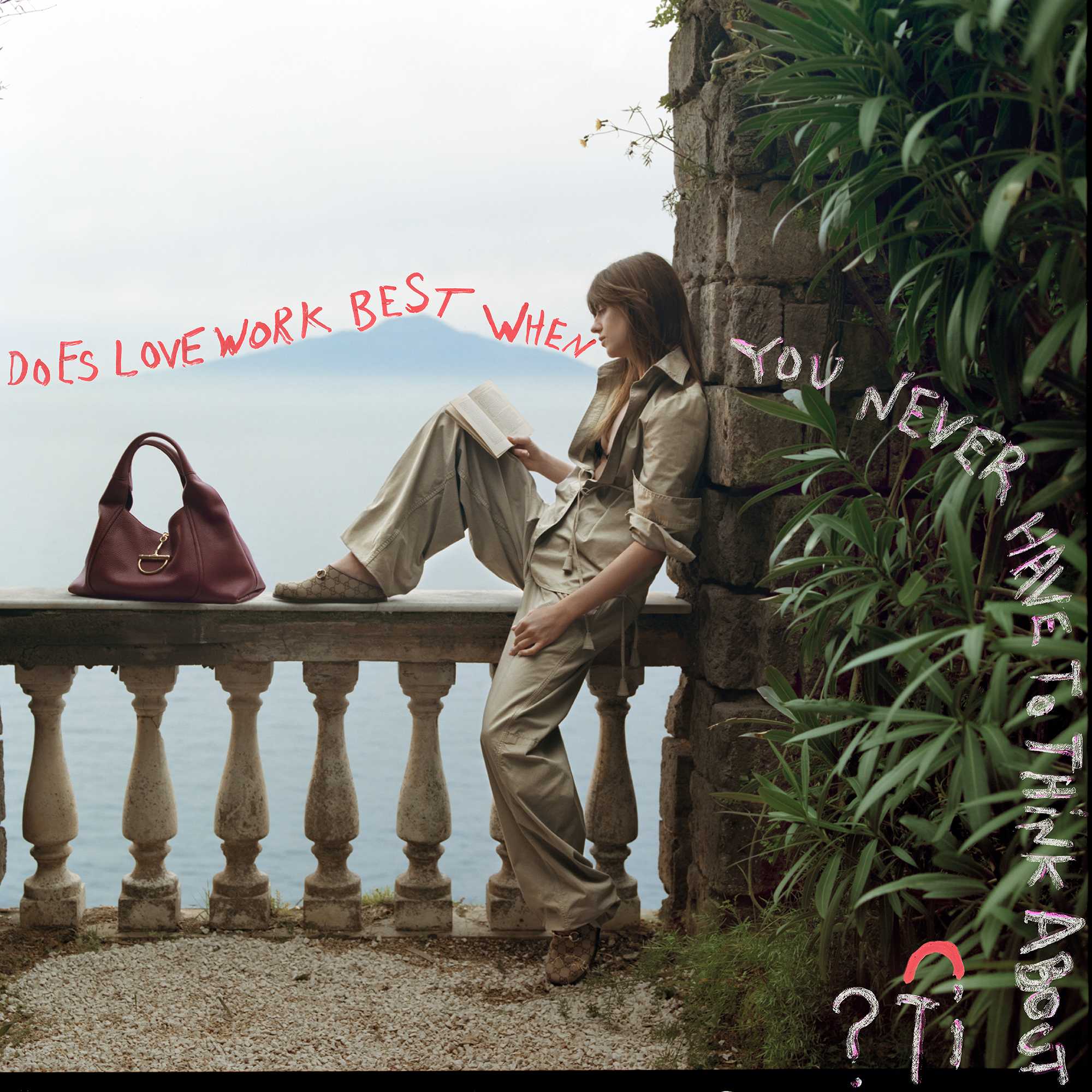 Burgundy Gucci bag beside reader