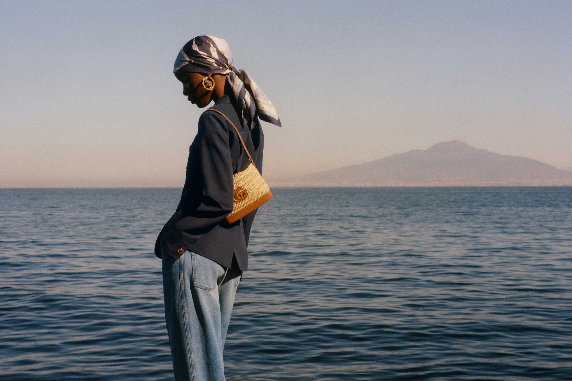 Golden Gucci bag by sea