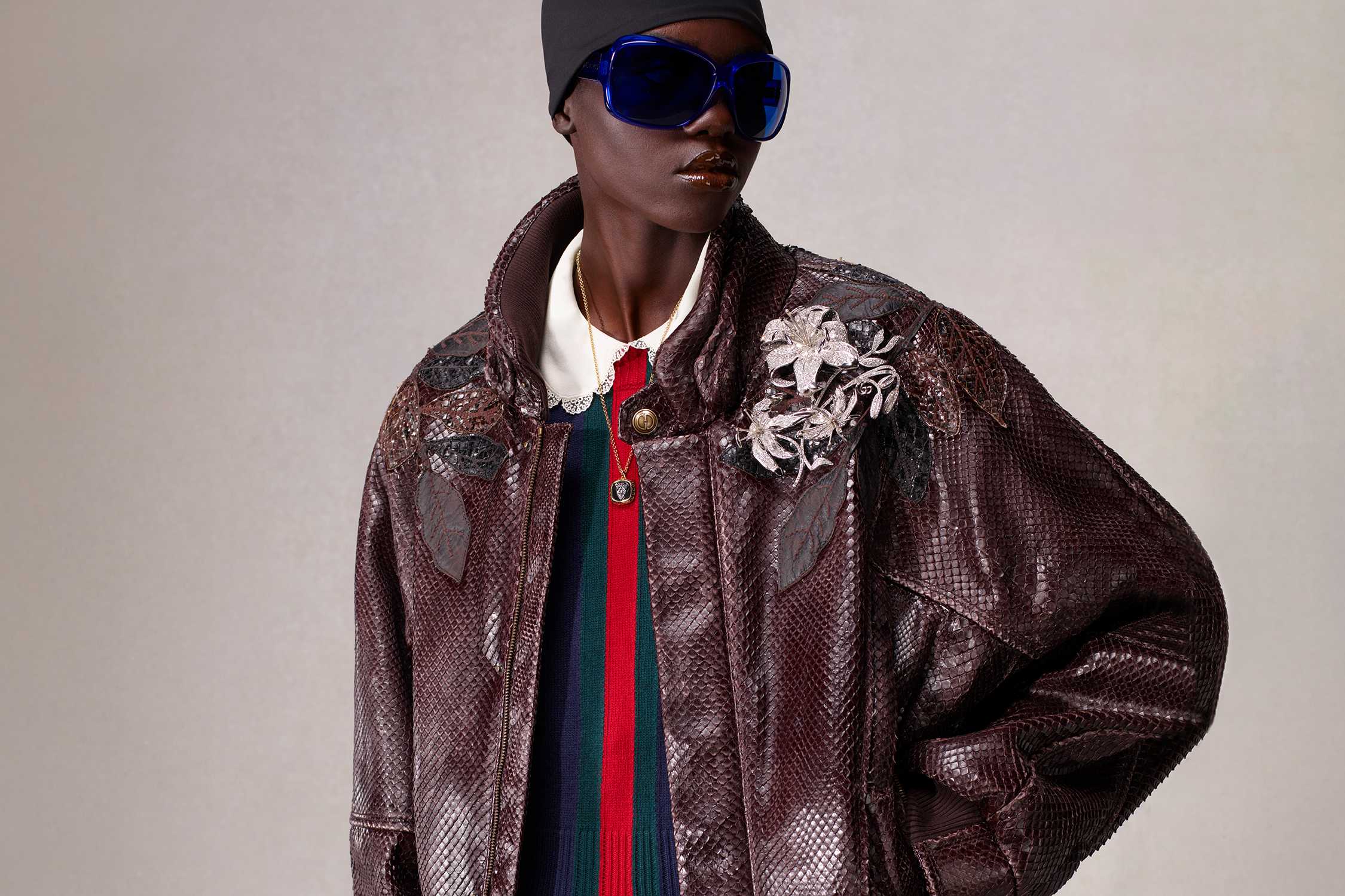 Brown Gucci jacket blue sunglasses