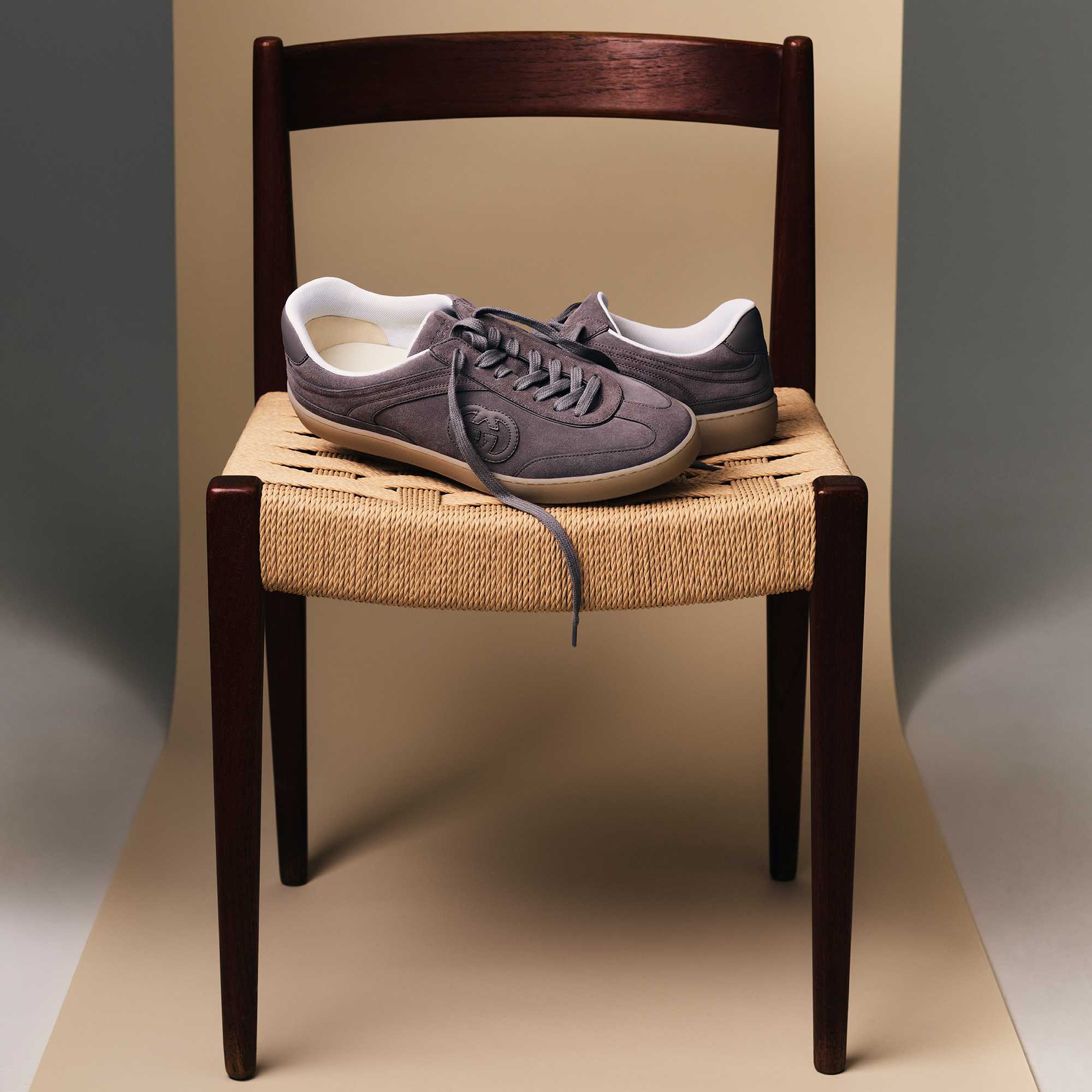 Grey Gucci sneakers on chair