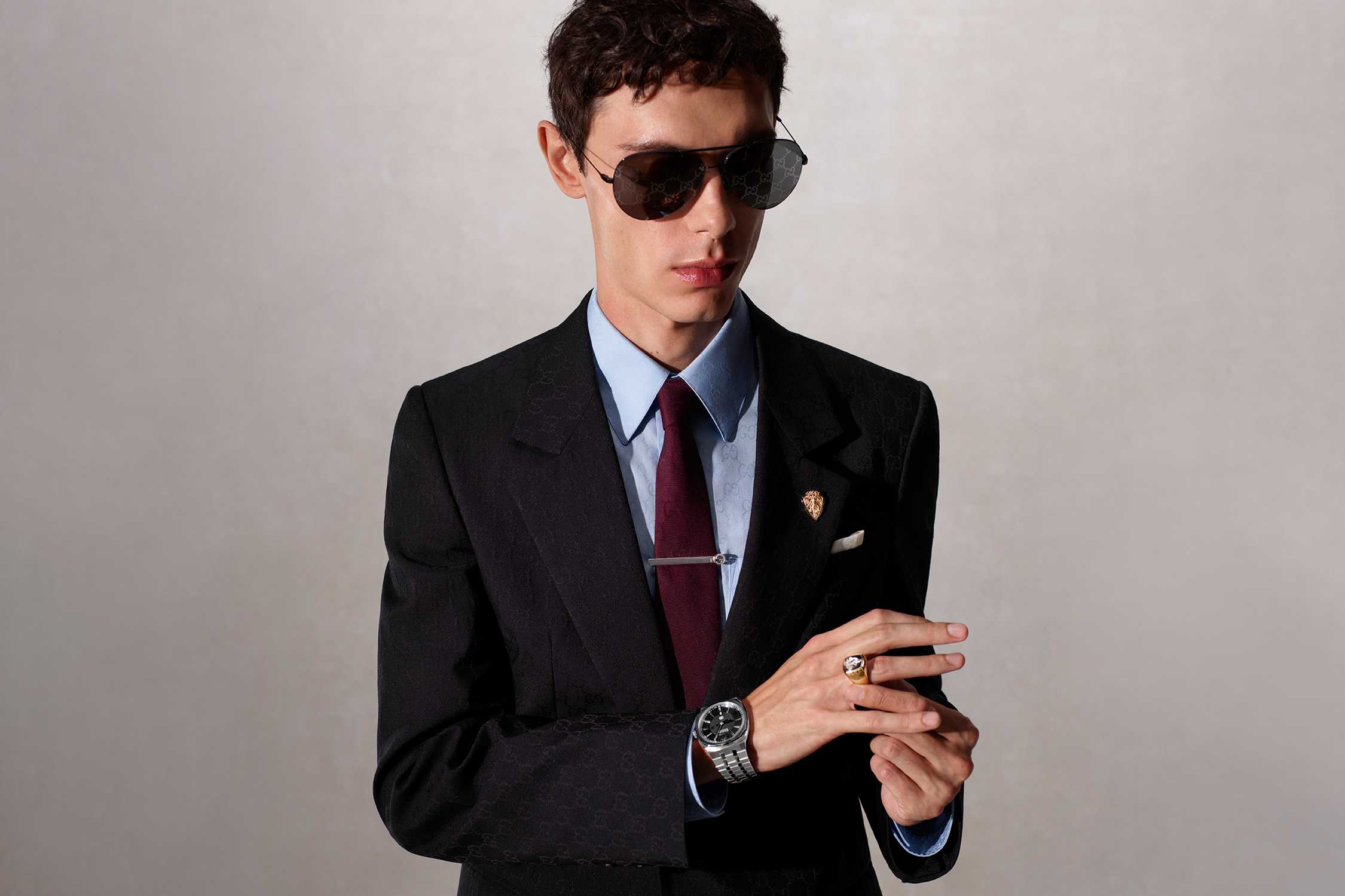 Black Gucci sunglasses and suit